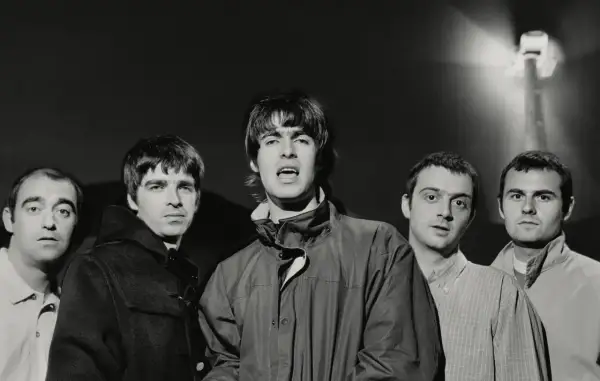 Oto członkowie jednego z najsłynniejszych zespołów rockowych, Oasis, pozujący do zdjęcia.